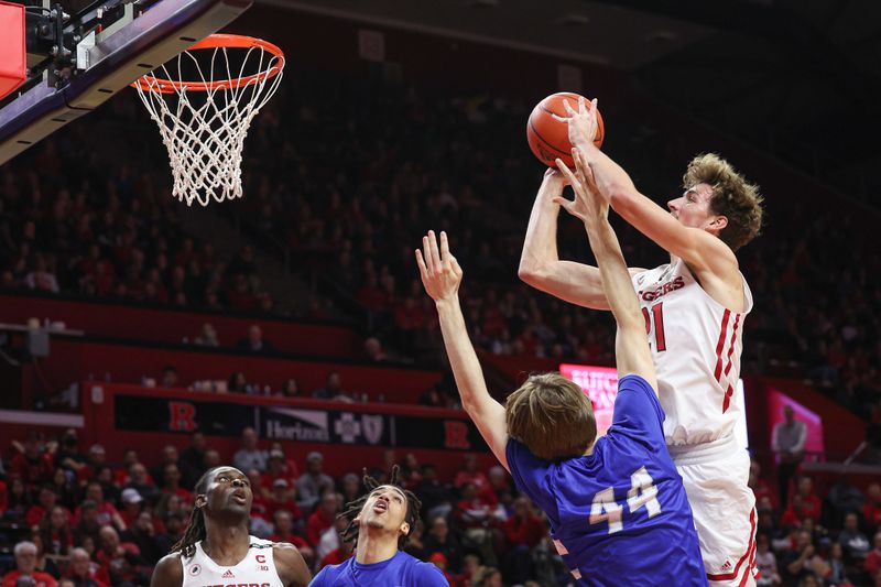 Nov 26, 2022; Piscataway, New Jersey, USA; Rutgers Scarlet Knights forward Dean Reiber (21) drives to the basket as Central Connecticut State Blue Devils forward Brody Limric (44) defends during the second half at Jersey Mike's Arena. Mandatory Credit: Vincent Carchietta-USA TODAY Sports