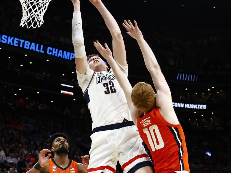 Mar 30, 2024; Boston, MA, USA; Connecticut Huskies center Donovan Clingan (32) shoots the ball over Illinois Fighting Illini guard Luke Goode (10) in the finals of the East Regional of the 2024 NCAA Tournament at TD Garden. Mandatory Credit: Winslow Townson-USA TODAY Sports
