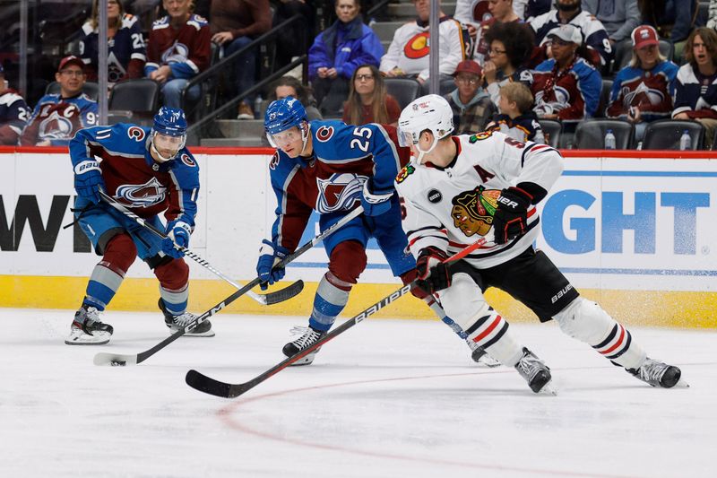 Oct 19, 2023; Denver, Colorado, USA; Colorado Avalanche right wing Logan O'Connor (25) controls the puck ahead of center Andrew Cogliano (11) as Chicago Blackhawks defenseman Connor Murphy (5) defends in the second period at Ball Arena. Mandatory Credit: Isaiah J. Downing-USA TODAY Sports