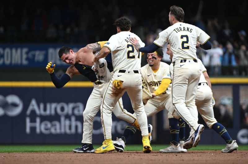 Apr 26, 2024; Milwaukee, Wisconsin, USA; Milwaukee Brewers catcher William Contreras (24), Milwaukee Brewers outfielder Sal Frelick (10) and Milwaukee Brewers shortstop Willy Adames (27) chase after Milwaukee Brewers third base Joey Ortiz (3) after hitting the game winning hit against the New York Yankees in the eleventh inning at American Family Field. Milwaukee Brewers 7, New York Yankees 6 in eleven innings. Mandatory Credit: Michael McLoone-USA TODAY Sports