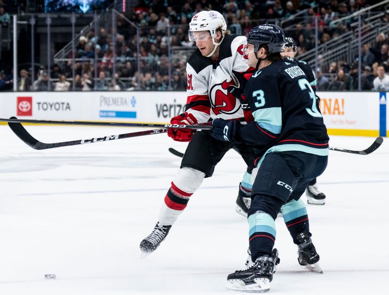 Dec 7, 2023; Seattle, Washington, USA; Seattle Kraken defenseman Will Borgen (3) and New Jersey Devils forward Dawson Mercer (91) collide during the first period at Climate Pledge Arena. Mandatory Credit: Stephen Brashear-USA TODAY Sports