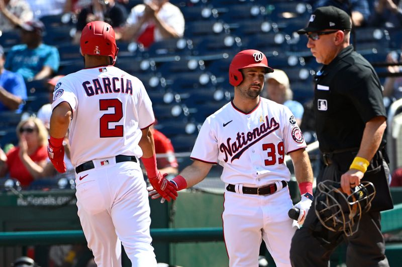 Sep 20, 2023; Washington, District of Columbia, USA; Washington Nationals second baseman Luis Garcia (2) is congratulated by third baseman Jake Alu (39) after scoring a run against the Chicago White Sox during the second inning at Nationals Park. Mandatory Credit: Brad Mills-USA TODAY Sports