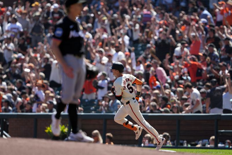 Sep 1, 2024; San Francisco, California, USA; San Francisco Giants right fielder Mike Yastrzemski (5) rounds the bases after hitting a home run against Miami Marlins starting pitcher Darren McCaughan (foreground left) during the first inning at Oracle Park. Mandatory Credit: Darren Yamashita-USA TODAY Sports