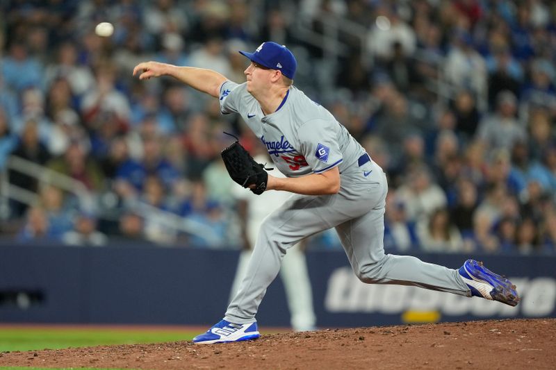 Apr 27, 2024; Toronto, Ontario, CAN; Los Angeles Dodgers pitcher Evan Phillips (59) pitches to the Toronto Blue Jays during the ninth inning at Rogers Centre. Mandatory Credit: John E. Sokolowski-USA TODAY Sports