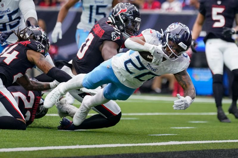 Tennessee Titans running back Tony Pollard (20) dives into the end zone to score a touchdown during the first half of an NFL football game against the Houston Texans, Sunday, Nov. 24, 2024, in Houston. (AP Photo/Eric Christian Smith)