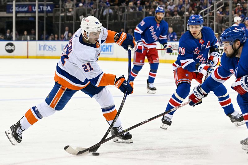 Apr 13, 2024; New York, New York, USA;  New York Islanders center Kyle Palmieri (21) attempts a shot defended by New York Rangers defenseman Ryan Lindgren (55) during the first period at Madison Square Garden. Mandatory Credit: Dennis Schneidler-USA TODAY Sports