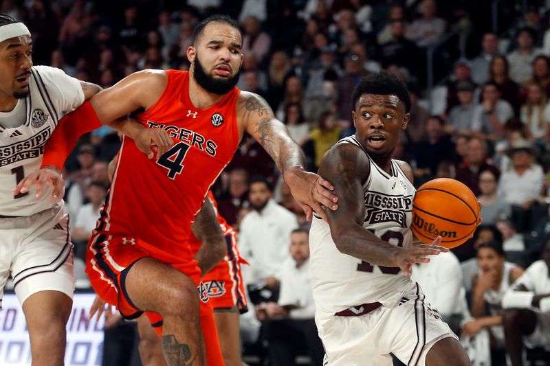 Jan 27, 2024; Starkville, Mississippi, USA; Mississippi State Bulldogs guard Dashawn Davis (10) drives to the basket as Auburn Tigers forward/center Johni Broome (4) defends during the second half at Humphrey Coliseum. Mandatory Credit: Petre Thomas-USA TODAY Sports