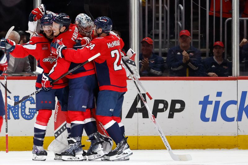 Oct 29, 2024; Washington, District of Columbia, USA; Washington Capitals center Nic Dowd (26) celebrates with teammates after scoring a goal after scoring an empty net goal against the New York Rangers in the third period at Capital One Arena. Mandatory Credit: Geoff Burke-Imagn Images