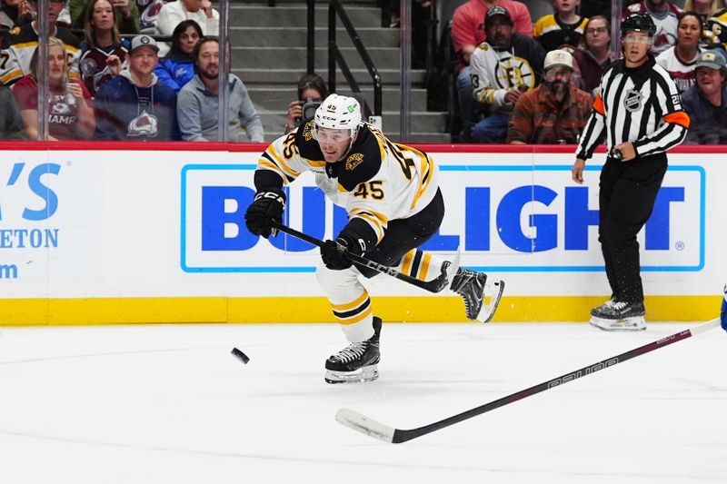 Oct 16, 2024; Denver, Colorado, USA; Boston Bruins left wing Cole Koepke (45) shoots the puck in the first period against the Colorado Avalanche at Ball Arena. Mandatory Credit: Ron Chenoy-Imagn Images