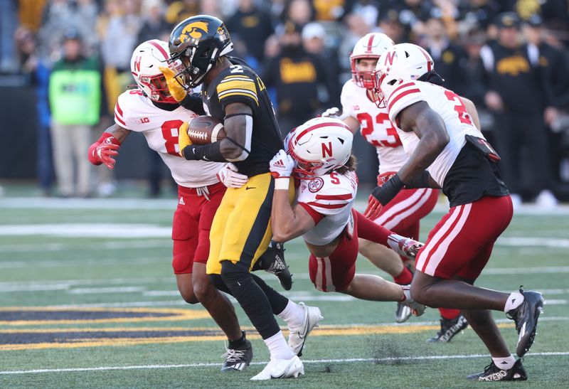 Nov 25, 2022; Iowa City, Iowa, USA; Nebraska Cornhuskers linebacker Eteva Mauga-Clements (5) tackles Iowa Hawkeyes running back Kaleb Johnson (2) at Kinnick Stadium. Mandatory Credit: Reese Strickland-USA TODAY Sports