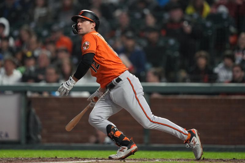 Jun 3, 2023; San Francisco, California, USA;  Baltimore Orioles second baseman Adam Frazier (12) hits a double against the San Francisco Giants during the sixth inning at Oracle Park. Mandatory Credit: Darren Yamashita-USA TODAY Sports