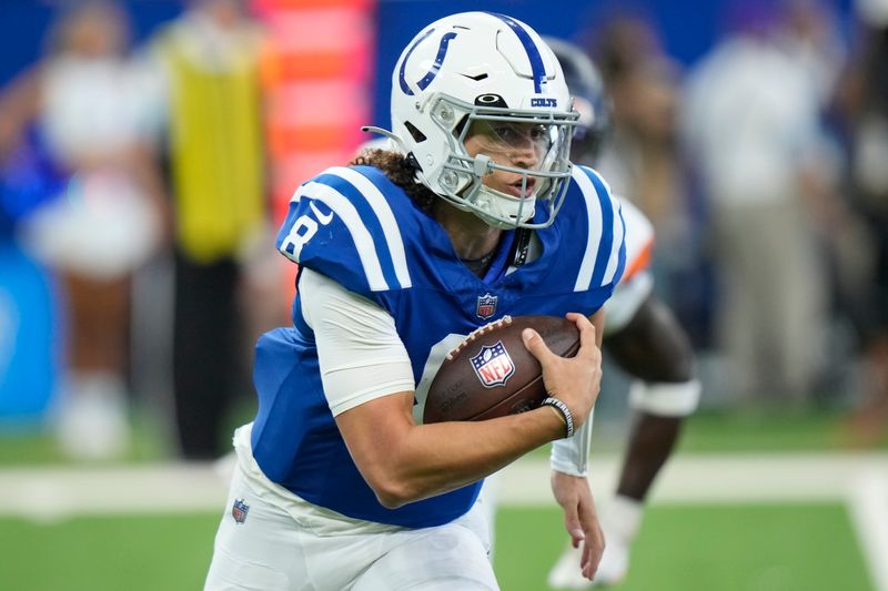 Indianapolis Colts quarterback Jason Bean carries the ball against the Denver Broncos during the second half of a preseason NFL football game, Sunday, Aug. 11, 2024, in Westfield, Ind. (AP Photo/AJ Mast)