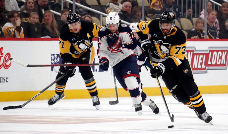 Mar 5, 2024; Pittsburgh, Pennsylvania, USA; Pittsburgh Penguins defenseman Pierre-Olivier Joseph (73) leads a break-out up ice against the Columbus Blue Jackets during the first period at PPG Paints Arena. Mandatory Credit: Charles LeClaire-USA TODAY Sports