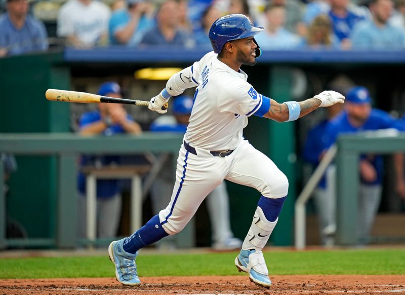 Apr 24, 2024; Kansas City, Missouri, USA; Kansas City Royals third base Maikel Garcia (11) hits an RBI single during the second inning against the Toronto Blue Jays at Kauffman Stadium. Mandatory Credit: Jay Biggerstaff-USA TODAY Sports