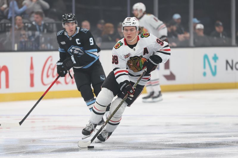 Mar 12, 2026; Salt Lake City, Utah, USA; Chicago Blackhawks center Connor Bedard (98) skates with the puck against the Utah Mammoth during the first period at Delta Center. Mandatory Credit: Rob Gray-Imagn Images