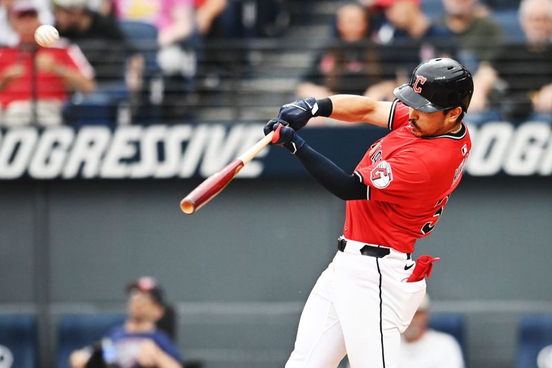 Jun 8, 2025; Cleveland, Ohio, USA; Cleveland Guardians left fielder Steven Kwan (38) hits a sacrifice fly during the seventh inning against the Houston Astros at Progressive Field. Mandatory Credit: Ken Blaze-Imagn Images