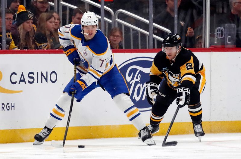 Jan 6, 2024; Pittsburgh, Pennsylvania, USA;  Buffalo Sabres right wing JJ Peterka (77) handles the puck against Pittsburgh Penguins defenseman Chad Ruhwedel (2) during the second period at PPG Paints Arena. Buffalo won 3-1. Mandatory Credit: Charles LeClaire-USA TODAY Sports