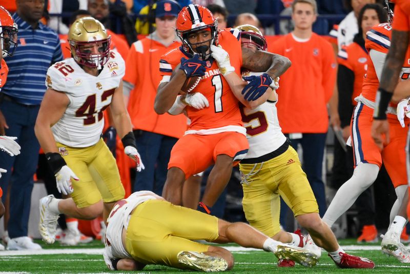 Nov 3, 2023; Syracuse, New York, USA; Boston College Eagles defensive back Cole Batson (23) and defensive back John Pupel (35) combine to tackle Syracuse Orange running back LeQuint Allen (1) during the first half at the JMA Wireless Dome. Mandatory Credit: Rich Barnes-USA TODAY Sports