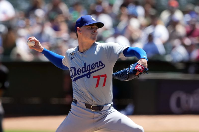 Aug 4, 2024; Oakland, California, USA; Los Angeles Dodgers starting pitcher River Ryan (77) throws a pitch against the Oakland Athletics during the first inning at Oakland-Alameda County Coliseum. Mandatory Credit: Darren Yamashita-USA TODAY Sports