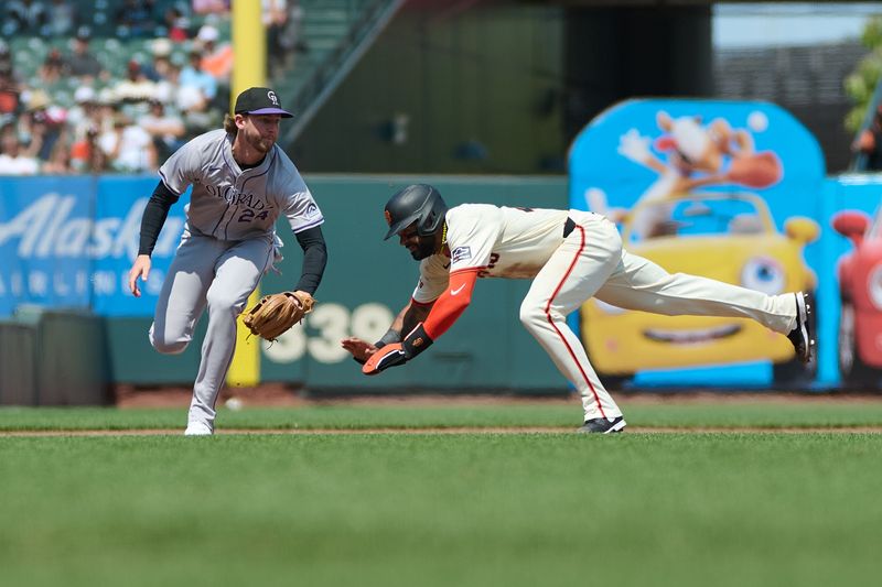 Jul 28, 2024; San Francisco, California, USA; San Francisco Giants outfielder Derek Hill (48) starts to slide as Colorado Rockies infielder Ryan McMahon (24) tries to field a ground ball during the sixth inning at Oracle Park. Mandatory Credit: Robert Edwards-USA TODAY Sports