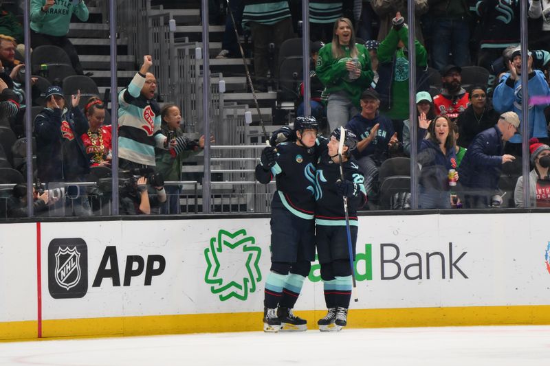 Mar 15, 2026; Seattle, Washington, USA; Seattle Kraken right wing Kaapo Kakko (84) and center Berkly Catton (27) celebrate after a goal scored by Kakko against the Florida Panthers during the second period at Climate Pledge Arena. Mandatory Credit: Steven Bisig-Imagn Images