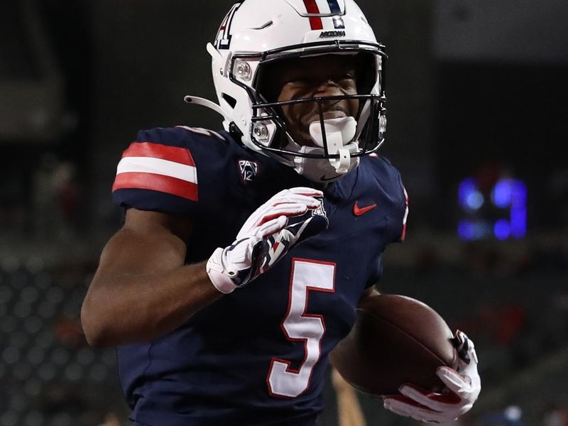 Sep 16, 2023; Tucson, Arizona, USA; Arizona Wildcats wide receiver Montana Lemonious-Craig (5) celebrates after scoring a touchdown against the UTEP Miners during the second half at Arizona Stadium. Mandatory Credit: Zachary BonDurant-USA TODAY Sports