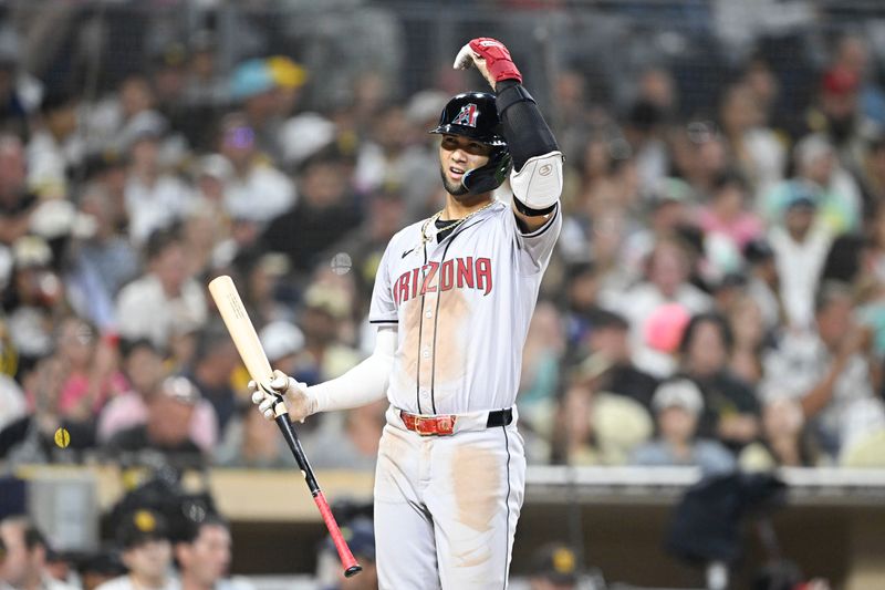 July 5, 2024; San Diego, California, USA; Arizona Diamondbacks left fielder Lourdes Gurriel Jr. (12) reacts after taking a strike during the sixth inning against the San Diego Padres at Petco Park. Mandatory Credit: Denis Poroy-USA TODAY Sports