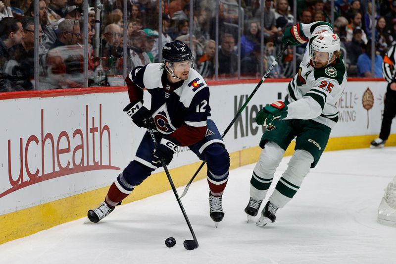 Apr 9, 2024; Denver, Colorado, USA; Colorado Avalanche right wing Brandon Duhaime (12) controls the puck ahead of Minnesota Wild defenseman Jonas Brodin (25) in the second period at Ball Arena. Mandatory Credit: Isaiah J. Downing-USA TODAY Sports