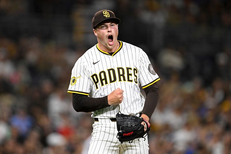 Sep 9, 2025; San Diego, California, USA; San Diego Padres relief pitcher Mason Miller (22) celebrates after striking out a batter during the eighth inning against the Cincinnati Reds at Petco Park. Mandatory Credit: Denis Poroy-Imagn Images