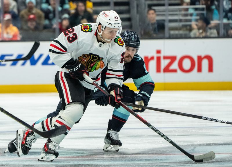 Nov 14, 2024; Seattle, Washington, USA;  Chicago Blackhawks forward Philipp Kurashev (23) skates against Seattle Kraken forward Chandler Stephenson (9) during the second period at Climate Pledge Arena. Mandatory Credit: Stephen Brashear-Imagn Images