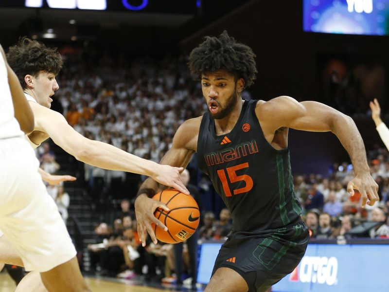 Feb 5, 2024; Charlottesville, Virginia, USA; Miami (Fl) Hurricanes forward Norchad Omier (15) dribbles the ball as Virginia Cavaliers forward Blake Buchanan (0) defends during the first half at John Paul Jones Arena. Mandatory Credit: Amber Searls-USA TODAY Sports