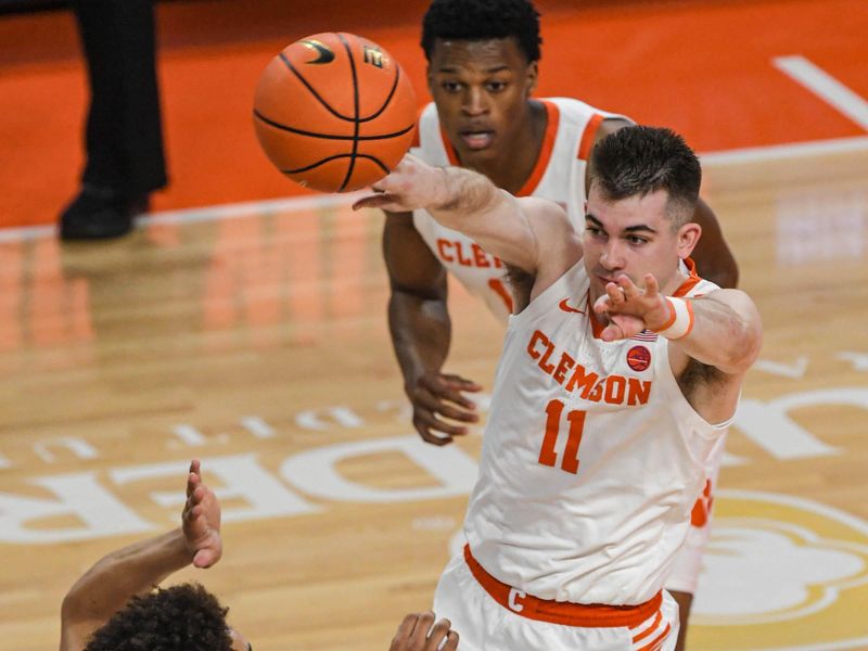 Jan 6, 2024; Clemson, South Carolina, USA; Clemson graduate Joseph Girard III  poses near University of North Carolina guard Seth Trimble (7) during the first half at Littlejohn Coliseum. Mandatory Credit: Ken Ruinard-USA TODAY Sports