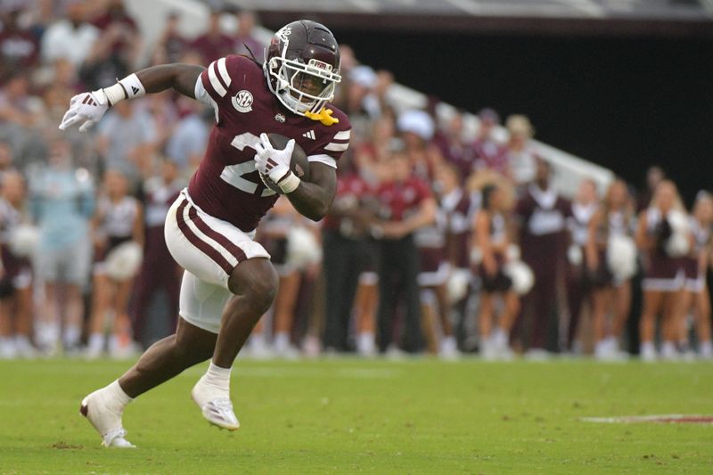 Nov 2, 2024; Starkville, Mississippi, USA; Mississippi State Bulldogs running back Davon Booth (21) runs the ball against the Massachusetts Minutemen during the third quarter at Davis Wade Stadium at Scott Field. Mandatory Credit: Matt Bush-Imagn Images