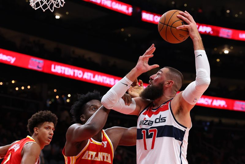 ATLANTA, GEORGIA - OCTOBER 28:  Jonas Valanciunas #17 of the Washington Wizards draws a foul by Clint Capela #15 of the Atlanta Hawks during the second quarter at State Farm Arena on October 28, 2024 in Atlanta, Georgia.  NOTE TO USER: User expressly acknowledges and agrees that, by downloading and/or using this photograph, user is consenting to the terms and conditions of the Getty Images License Agreement.  (Photo by Kevin C. Cox/Getty Images)