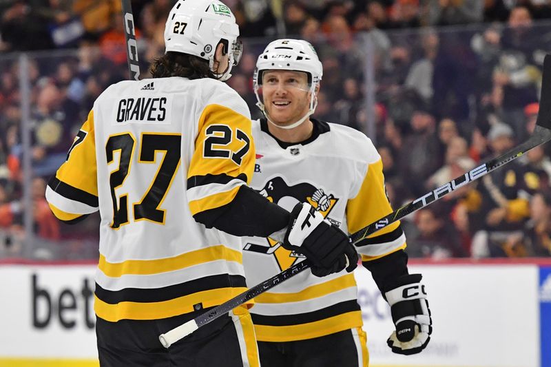 Jan 8, 2024; Philadelphia, Pennsylvania, USA; Pittsburgh Penguins defenseman Chad Ruhwedel (2) celebrates his goal with defenseman Ryan Graves (27) against the Philadelphia Flyers during the second period at Wells Fargo Center. Mandatory Credit: Eric Hartline-USA TODAY Sports