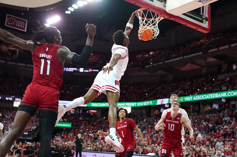 Mar 7, 2024; Madison, Wisconsin, USA; Wisconsin Badgers guard AJ Storr (2) dunks the ball against Rutgers Scarlet Knights center Clifford Omoruyi (11) during the second half at the Kohl Center. Mandatory Credit: Kayla Wolf-USA TODAY Sports