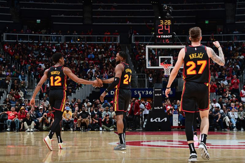 ATLANTA, GA - APRIL 9: De'Andre Hunter #12, Bruno Fernando #24 and Vit Krejci #27 of the Atlanta Hawks celebrate during the game against the Miami Heat on April 9, 2024 at State Farm Arena in Atlanta, Georgia.  NOTE TO USER: User expressly acknowledges and agrees that, by downloading and/or using this Photograph, user is consenting to the terms and conditions of the Getty Images License Agreement. Mandatory Copyright Notice: Copyright 2024 NBAE (Photo by Scott Cunningham/NBAE via Getty Images)