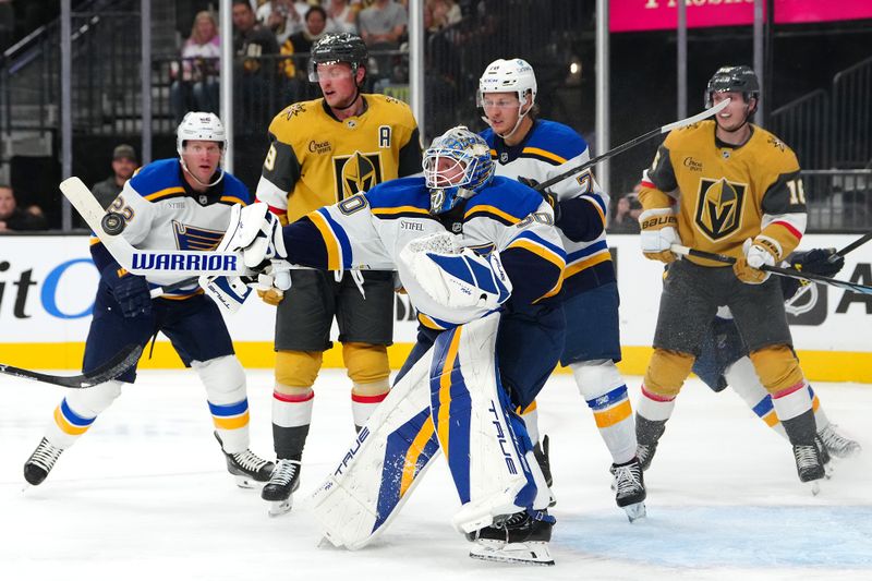 Oct 11, 2024; Las Vegas, Nevada, USA; St. Louis Blues goaltender Jordan Binnington (50) looks to control the puck after making a save against the Vegas Golden Knights during the second period at T-Mobile Arena. Mandatory Credit: Stephen R. Sylvanie-Imagn Images