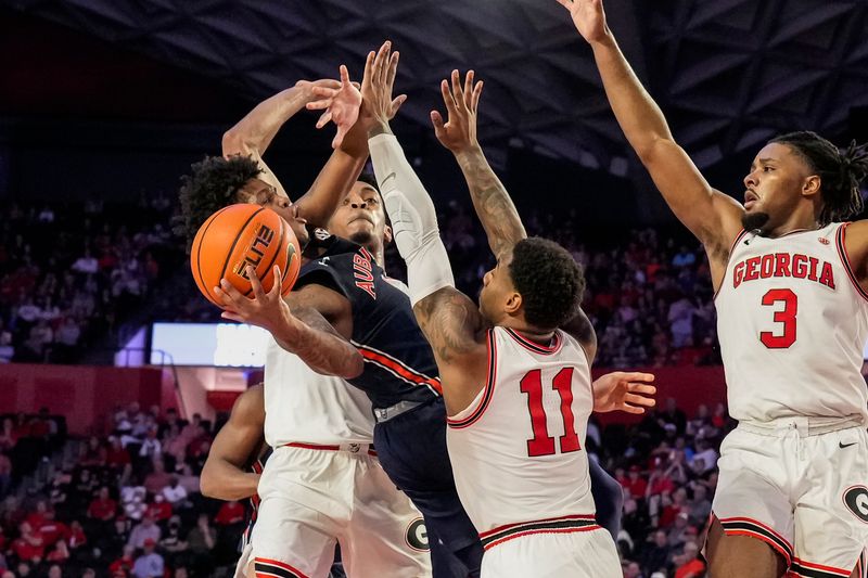 Jan 4, 2023; Athens, Georgia, USA; Auburn Tigers guard Wendell Green Jr. (1) tries to shoot defended by Georgia Bulldogs center Frank Anselem (5) and guard Justin Hill (11) during the first half at Stegeman Coliseum. Mandatory Credit: Dale Zanine-USA TODAY Sports