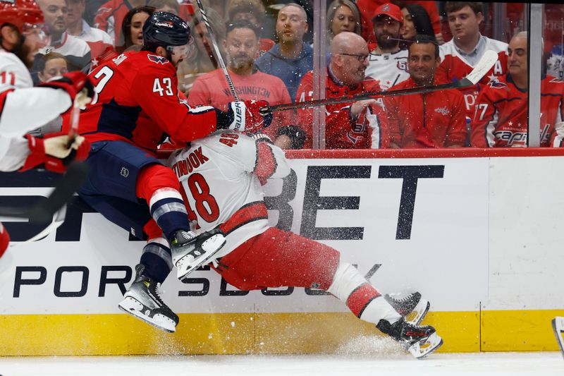 May 8, 2025; Washington, District of Columbia, USA; Washington Capitals right wing Tom Wilson (43) c checks Carolina Hurricanes left wing Jordan Martinook (48) in the first period in game two of the second round of the 2025 Stanley Cup Playoffs at Capital One Arena. Mandatory Credit: Geoff Burke-Imagn Images