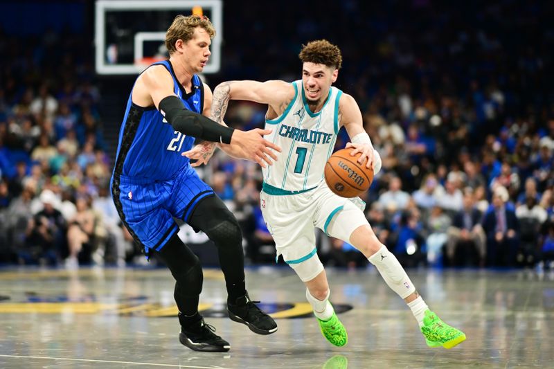 ORLANDO, FLORIDA - NOVEMBER 12: LaMelo Ball #1 of the Charlotte Hornets drives to the basket against Moritz Wagner #21 of the Orlando Magic in the first half during an Emirates NBA Cup game at Kia Center on November 12, 2024 in Orlando, Florida. NOTE TO USER: User expressly acknowledges and agrees that, by downloading and or using this photograph, User is consenting to the terms and conditions of the Getty Images License Agreement. (Photo by Julio Aguilar/Getty Images)