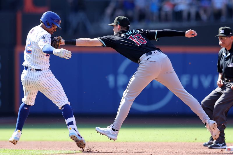 Jun 1, 2024; New York City, New York, USA; New York Mets shortstop Francisco Lindor (12) is tagged out trying to stretch a single into a double by Arizona Diamondbacks shortstop Kevin Newman (18) during the first inning at Citi Field. Mandatory Credit: Brad Penner-USA TODAY Sports