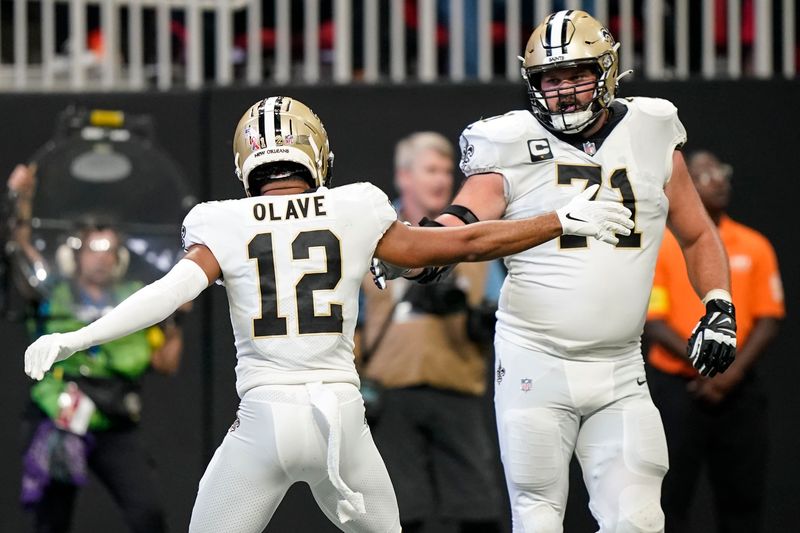 New Orleans Saints wide receiver Chris Olave (12) celebrates his touchdown against the Atlanta Falcons during the second half of an NFL football game, Sunday, Sept. 11, 2022, in Atlanta. (AP Photo/Brynn Anderson)