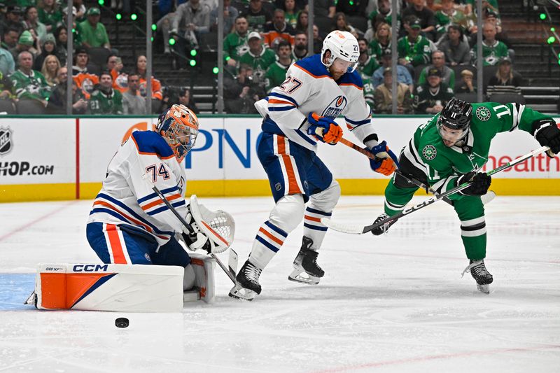 May 25, 2024; Dallas, Texas, USA; Edmonton Oilers goaltender Stuart Skinner (74) stops a shot by Dallas Stars center Logan Stankoven (11) as defenseman Brett Kulak (27) looks on during the second period in game two of the Western Conference Final of the 2024 Stanley Cup Playoffs at American Airlines Center. Mandatory Credit: Jerome Miron-USA TODAY Sports