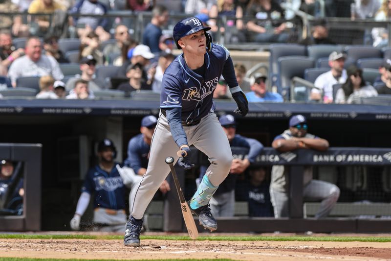 Apr 20, 2024; Bronx, New York, USA; Tampa Bay Rays second base Curtis Mead (25) hits a single against the New York Yankees during the fifth inning at Yankee Stadium. Mandatory Credit: John Jones-USA TODAY Sports