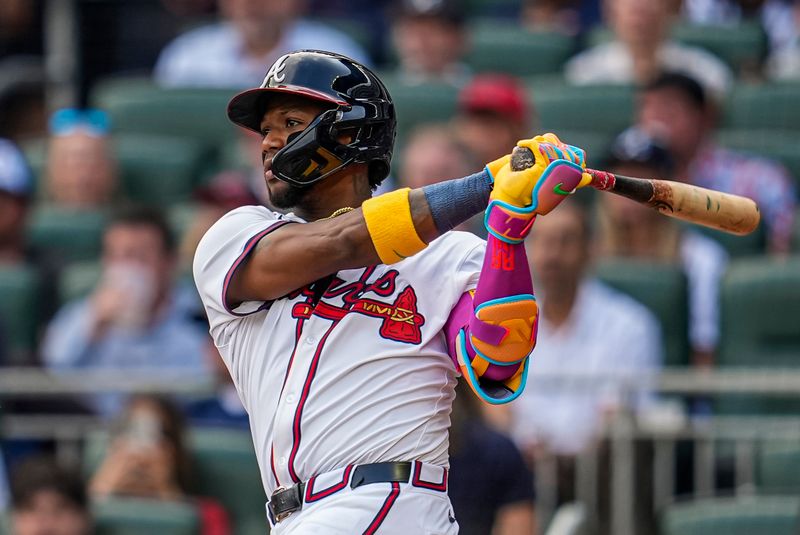 May 25, 2025; Cumberland, Georgia, USA; Atlanta Braves right fielder Ronald Acuna Jr (13) hits a double against the San Diego Padres during the fifth inning at Truist Park. Mandatory Credit: Dale Zanine-Imagn Images
