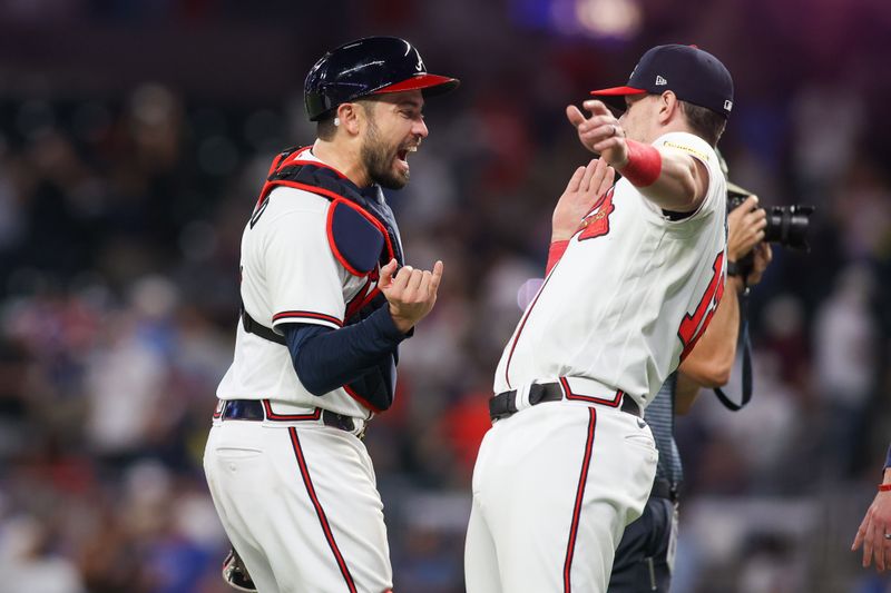 Aug 16, 2023; Atlanta, Georgia, USA; Atlanta Braves catcher Travis d'Arnaud (16) and catcher Sean Murphy (12) celebrate after a victory against the New York Yankees at Truist Park. Mandatory Credit: Brett Davis-USA TODAY Sports
