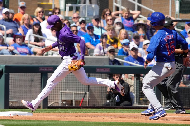 Mar 21, 2024; Salt River Pima-Maricopa, Arizona, USA; Colorado Rockies third baseman Julio Carreras (83) gets the force out on Chicago Cubs catcher Yan Gomes (15) in the third inning at Salt River Fields at Talking Stick. Mandatory Credit: Rick Scuteri-USA TODAY Sports