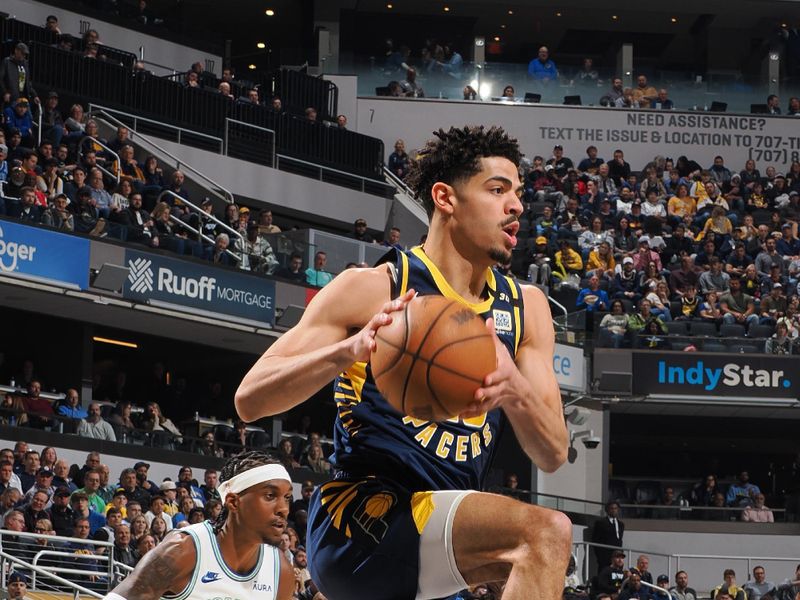 INDIANAPOLIS, IN - MARCH 7: Ben Sheppard #26 of the Indiana Pacers  grabs a rebound during the game against the Minnesota Timberwolves on March 7, 2024 at Gainbridge Fieldhouse in Indianapolis, Indiana. NOTE TO USER: User expressly acknowledges and agrees that, by downloading and or using this Photograph, user is consenting to the terms and conditions of the Getty Images License Agreement. Mandatory Copyright Notice: Copyright 2024 NBAE (Photo by Ron Hoskins/NBAE via Getty Images)