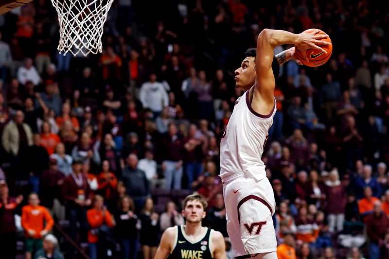 Mar 2, 2024; Blacksburg, Virginia, USA; Virginia Tech Hokies center Lynn Kidd (15) dunks the ball against Wake Forest Demon Deacons forward Andrew Carr (11) during the second half at Cassell Coliseum. Mandatory Credit: Peter Casey-USA TODAY Sports